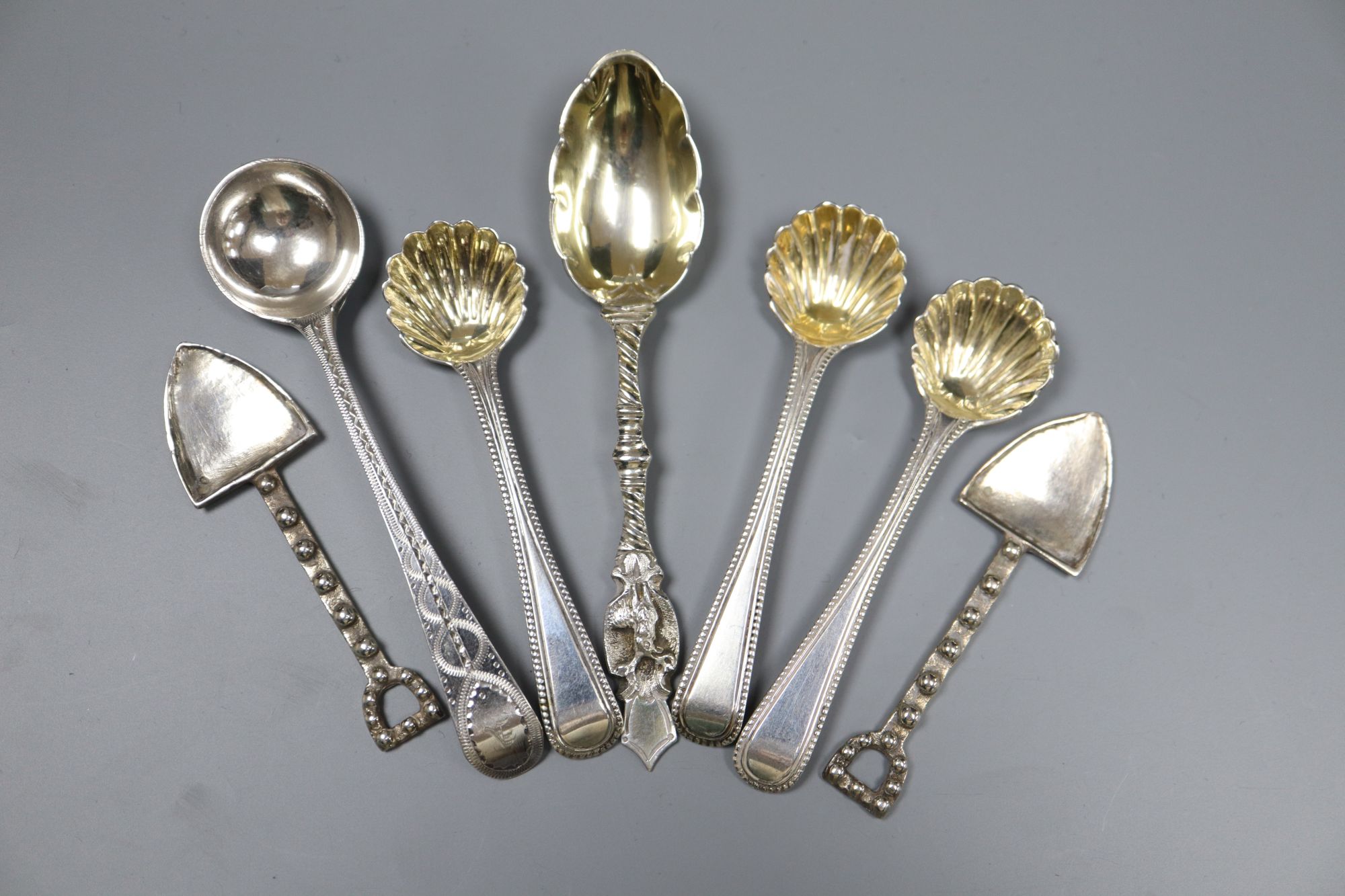 Five assorted 19th century silver condiment spoons and two white metal condiment shovels